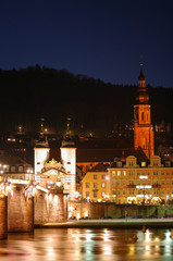 Fototapeta premium Night view with illumination of old bridge, downtown and castle in Heidelberg, Germany