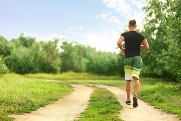 Sporty young man running outdoors