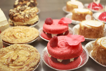 Showcase with cakes in pastry shop, close up