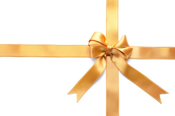Fototapeta premium Golden satin ribbons with bow on white background