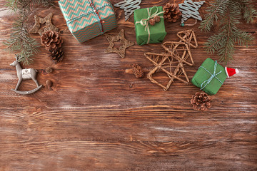 Beautiful Christmas gift boxes with decorations on wooden table