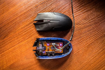 diodes glow on an exploded computer mouse