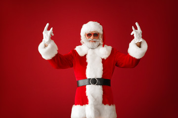 Portrait of cool Santa Claus on color background
