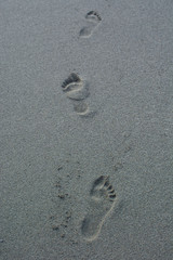 Human footprints on the sand beach.