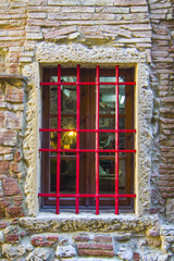 Fototapeta na wymiar window with red grating and light inside