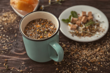 Cup of delicious camomile tea on wooden table