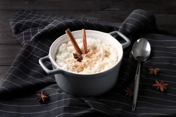 Delicious rice pudding with cinnamon and anise in casserole on table