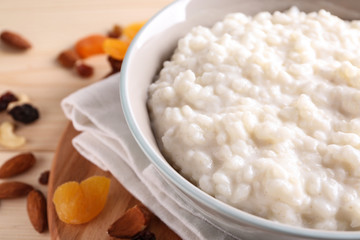 Delicious rice pudding in bowl on table, closeup