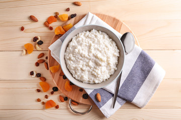 Delicious rice pudding in bowl on wooden table