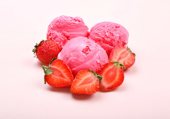 Tasty strawberry ice-cream balls on light background