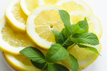 Set up created with plate full of lemon slices and fresh mint leaves.