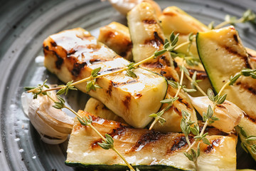 Tasty grilled zucchini on plate, closeup