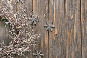 Christmas snowflakes and wreath on wooden background