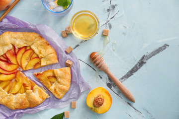 Parchment with delicious peach galette on light table
