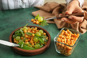 Woman eating healthy fresh salad, closeup