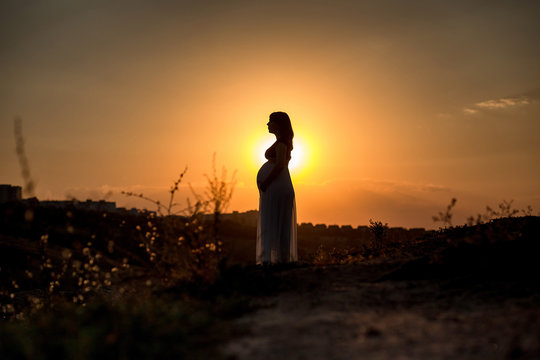 pregnant woman at sunset