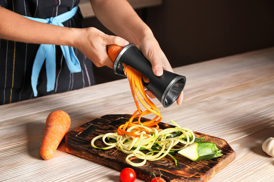 Woman making zucchini and carrot spaghetti