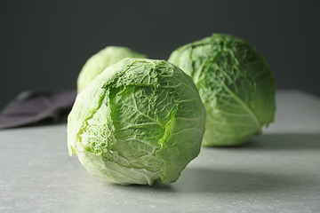 Fototapeta premium Fresh whole cabbage on grey table