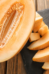 Sliced ripe melon on wooden table