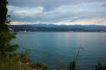 sea waterfront shore line of small resort city in tropic district in summer rainy weather time before storm