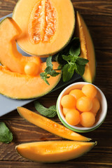 Composition with tasty melon on wooden table