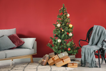 Stylish interior of room with beautiful Christmas tree and gifts
