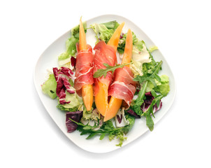 Delicious melon with prosciutto on white background