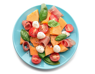 Delicious salad with melon and prosciutto on white background
