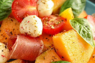 Delicious melon with prosciutto and mozzarella cheese, closeup