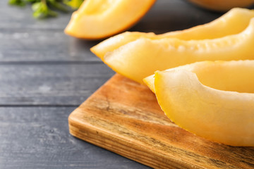 Slices of ripe melon on wooden board, closeup
