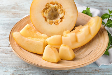 Sliced ripe melon on wooden plate