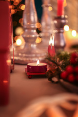 Burning candle on with Christmas decoration on table