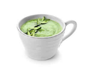 Tasty zucchini soup in cup on white background