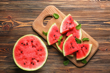 Sliced ripe watermelon on wooden table, top view