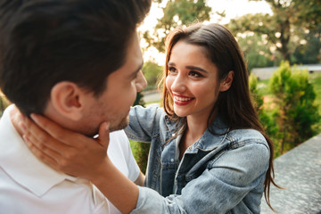 Obraz premium Loving couple walking outdoors while hugging.