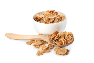 Bowl and spoon with healthy cornflakes on white background