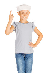 Little girl wearing a sailor costume and looking at the camera on white background.