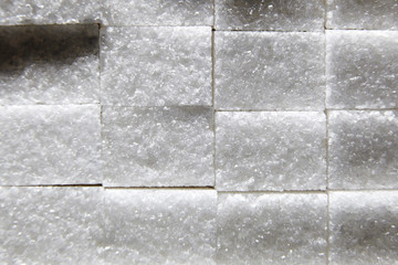 Sweet cubes of white sugar. Abstract background