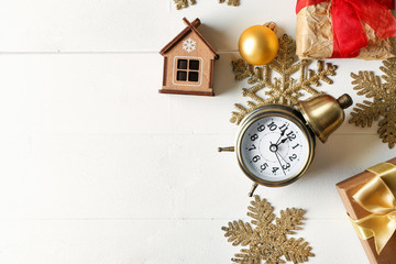 Composition with alarm clock, gifts and decorations on light background. Christmas countdown