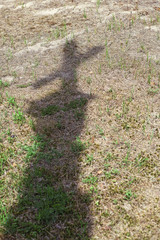 Shadow of the cross on the ground. Abandoned graveyard in summer