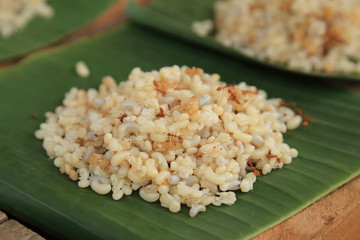 Pile of ant eggs with larva and weaver ants on green banana leaf. Delicious asian local food.