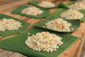 Pile of ant eggs with larva and weaver ants on green banana leaf. Delicious asian local food.