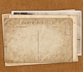 Vintage postcard on the leather texture background
