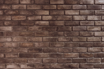 Brown grunge brick wall background. Texture and wallpaper concept. Material and construction theme. Dark room tone film
