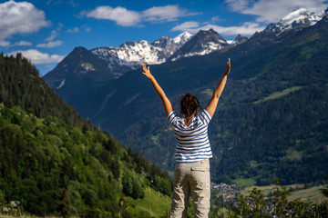 Obraz premium Female traveler admiring views of Swiss Alps in Val de Bagnes area, Switzerland.