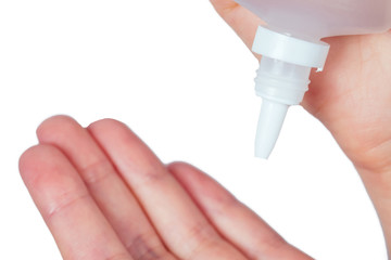 hands using cosmetic liquid soap nasal spray and eye drops close up