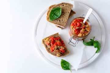 Rye bread toasts and glass jar with eggplant caviar. Vegetable appetizer or antipasti. Healthy food concept