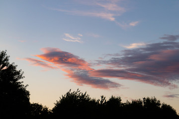 A large cloud tinged red at sunset