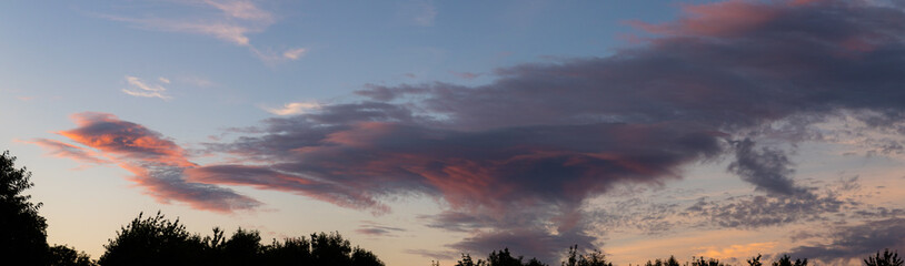 A large cloud tinged red at sunset