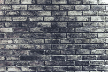Grunge brick wall background. Texture and wallpaper concept. Material and construction theme. Dark room tone film